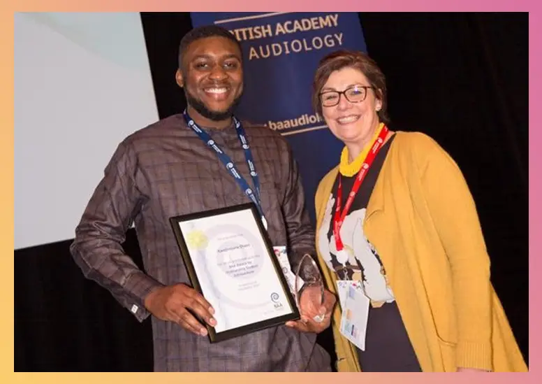 Awajimijana Otana receiving the Lisa-Bayliss Award from the British Academy of Audiology